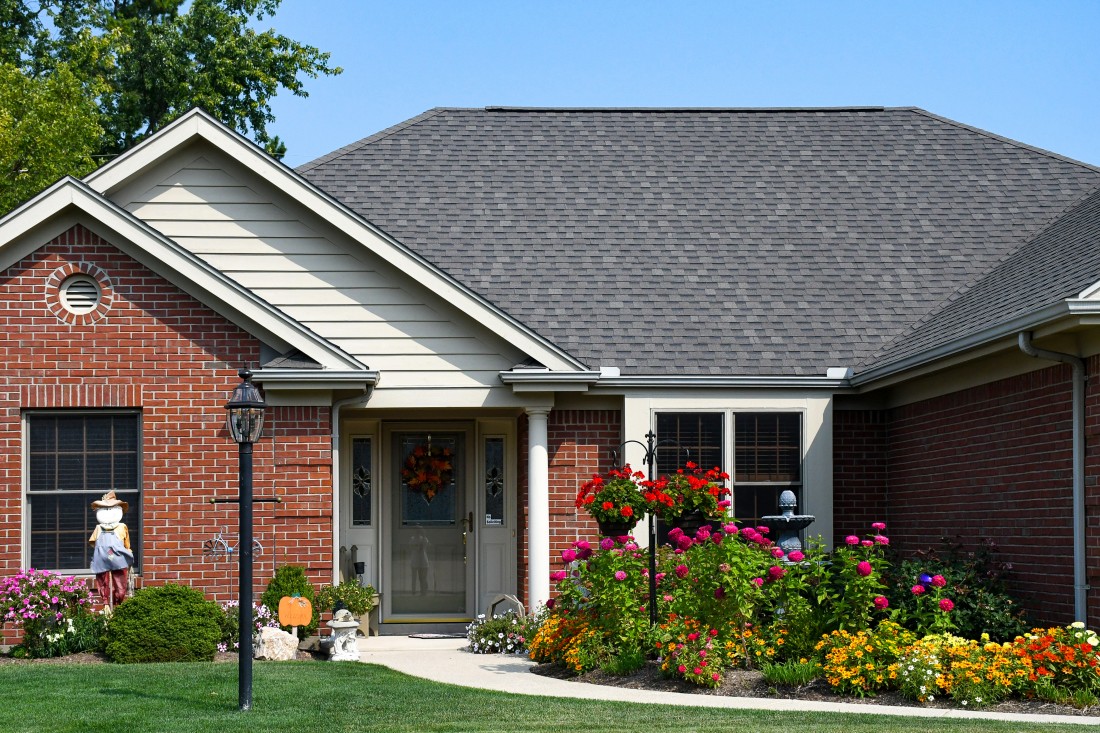 Beautiful house with greenery and flowers outside with good roofing system 