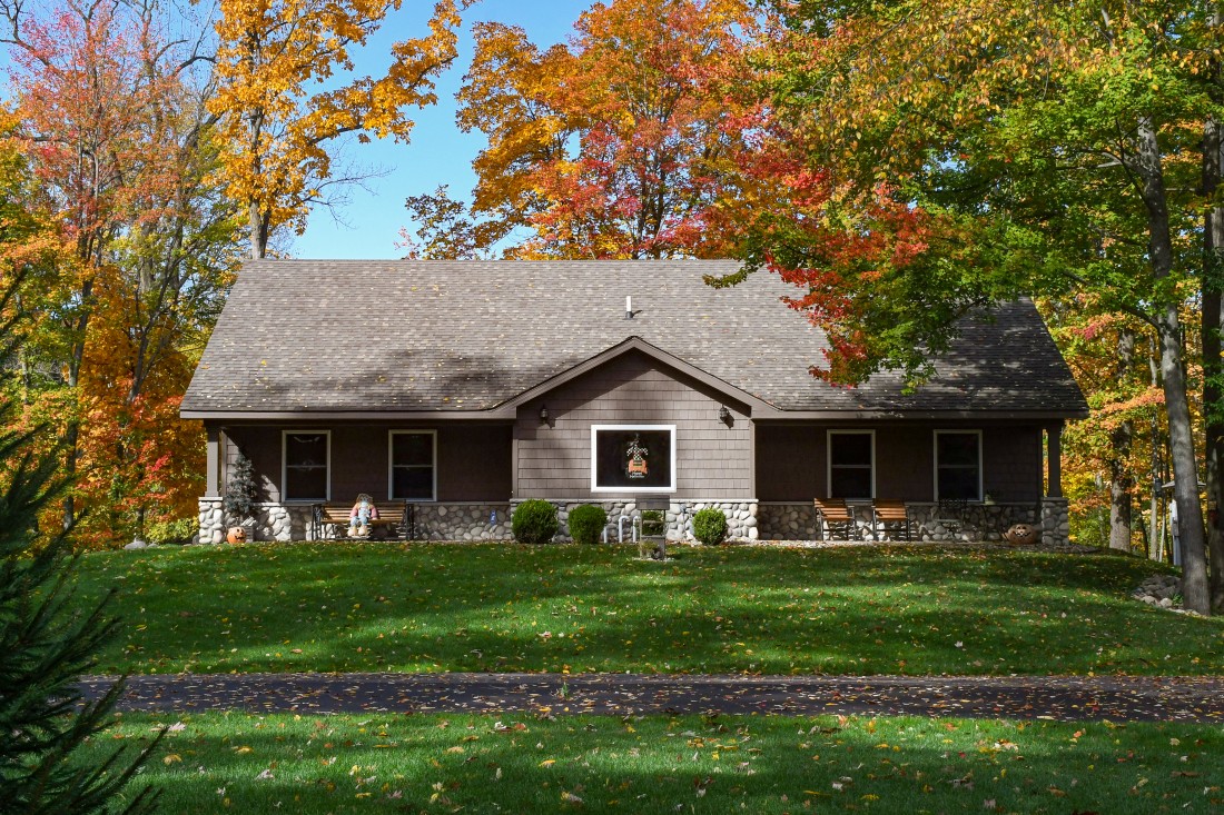 house with green grass and trees Infront of 